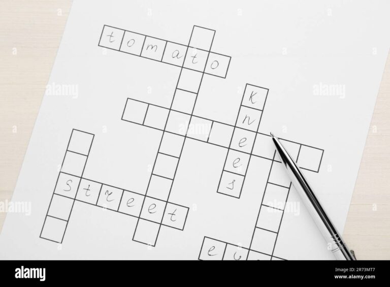 Crossword With Answers And Pen On White Wooden Table Top View Stock Photo Alamy